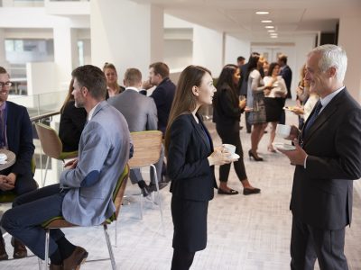 Delegates Networking During Coffee Break At Conference